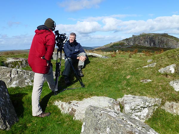 Andy Howard (BGS) at a vantage points looking towards Cheesewring Tor and granite quarry, Cornwall.